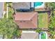 Birds-eye view of a home, displaying its roof, backyard, and proximity to a swimming pool and neighboring houses at 300 Augustine Ct, Oviedo, FL 32765