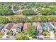 Expansive aerial view of the neighborhood featuring tree-lined streets and a glimpse of the lake at 300 Augustine Ct, Oviedo, FL 32765
