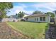 Spacious backyard featuring a well-maintained lawn, bordered by a wooden fence, and the home's exterior at 300 Augustine Ct, Oviedo, FL 32765