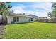 Lush green backyard with a sturdy wooden fence and views of the house's back exterior at 300 Augustine Ct, Oviedo, FL 32765