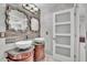 Bathroom featuring double sinks with granite countertops, decorative mirrors and gray tile at 300 Augustine Ct, Oviedo, FL 32765