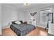 Bright bedroom featuring hardwood floors, a vanity, and a decorative floral wall accent at 300 Augustine Ct, Oviedo, FL 32765