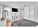 Bedroom with hardwood floors, closet space, and a television mounted on the wall at 300 Augustine Ct, Oviedo, FL 32765