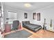 Bedroom with a black platform bed, a dark wood desk, and musical instrument decor at 300 Augustine Ct, Oviedo, FL 32765