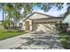 Inviting front exterior showcasing a spacious driveway and well-maintained landscaping at 300 Augustine Ct, Oviedo, FL 32765