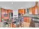 Kitchen with stainless steel appliances, island with bar stools, and wooden cabinets at 300 Augustine Ct, Oviedo, FL 32765