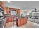 Kitchen with wooden cabinets, island with bar stools, and open floor plan at 300 Augustine Ct, Oviedo, FL 32765