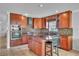 View of kitchen with stainless steel appliances, island with bar stools, and tile flooring at 300 Augustine Ct, Oviedo, FL 32765
