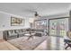 Spacious living room featuring a large sectional sofa and tile floors and access to outside at 300 Augustine Ct, Oviedo, FL 32765