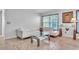 Comfortable living room area featuring neutral tones and tiled flooring at 300 Augustine Ct, Oviedo, FL 32765