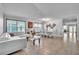 Open-concept living space with tile floors, white sofa, and dining area at 300 Augustine Ct, Oviedo, FL 32765