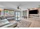 Open concept living area featuring modern furniture, tile flooring, and brick entertainment wall at 300 Augustine Ct, Oviedo, FL 32765