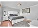 View of a bedroom with hardwood floors, neutral walls, and a statement art piece above the bed at 300 Augustine Ct, Oviedo, FL 32765