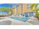Relaxing Galleria hotel pool with lounge chairs and palm trees at 3000 Maingate Ln # 504, Kissimmee, FL 34747