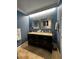 Elegant bathroom featuring a double vanity, granite countertop, framed mirrors, and modern fixtures at 3063 Ash Park Loop, Winter Park, FL 32792