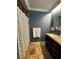 Stylish bathroom boasts a dark wood vanity, granite countertop, and textured shower curtain at 3063 Ash Park Loop, Winter Park, FL 32792