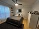 Cozy bedroom with a comfortable bed, soft lighting, and a dark rug over wood floors at 3063 Ash Park Loop, Winter Park, FL 32792