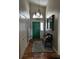 Inviting foyer with tiled floor, a green front door, and a comfortable bench at 3063 Ash Park Loop, Winter Park, FL 32792