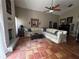 Spacious living room with a fireplace, ample seating and terracotta tile at 3063 Ash Park Loop, Winter Park, FL 32792