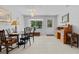 Bright dining area with tiled floors, chandelier, and front door access at 314 Avalone Dr, Apopka, FL 32703
