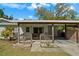 Inviting covered front porch with wooden railings and cozy seating area at 314 Avalone Dr, Apopka, FL 32703