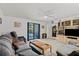 Spacious living room featuring carpet floors and a view of the pool through sliding glass doors at 314 Avalone Dr, Apopka, FL 32703