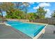 Sparkling pool surrounded by concrete patio and wooden fence, perfect for backyard relaxation and privacy at 314 Avalone Dr, Apopka, FL 32703