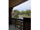 Balcony view showcasing lush landscaping, residences, and a large parking area at 315 Lakepointe Dr # 201, Altamonte Springs, FL 32701
