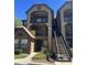 Condo building featuring a balcony and staircase leading to upper-level units at 315 Lakepointe Dr # 201, Altamonte Springs, FL 32701