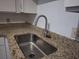 Close-up of a stainless steel sink and stone countertops in the kitchen at 315 Lakepointe Dr # 201, Altamonte Springs, FL 32701