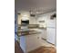 Bright kitchen with white cabinets, stone countertops, and modern appliances at 315 Lakepointe Dr # 201, Altamonte Springs, FL 32701