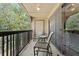 Relaxing balcony area with seating and views of the surrounding greenery at 325 Lakepointe Dr # 303, Altamonte Springs, FL 32701