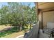Enjoy lush green views from this charming balcony with mature trees and an outdoor chair at 325 Lakepointe Dr # 303, Altamonte Springs, FL 32701