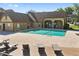 Community pool with adjacent seating area and lounge chairs at 325 Lakepointe Dr # 303, Altamonte Springs, FL 32701