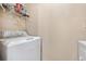 Bright laundry room featuring a modern washing machine with metal shelving, offering convenient organization at 325 Lakepointe Dr # 303, Altamonte Springs, FL 32701