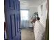 A partially visible bedroom with blue trim, neutral carpeting, and minimal storage solutions at 330 S Buena Vista Ave, Orlando, FL 32835