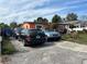 Residential area with multiple parked cars in front of an orange single-story home at 330 S Buena Vista Ave, Orlando, FL 32835