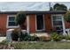 Charming single-story home with an orange exterior and well-maintained landscaping at 330 S Buena Vista Ave, Orlando, FL 32835