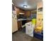 Compact kitchen with wooden cabinets, essential appliances, and tiled backsplash at 330 S Buena Vista Ave, Orlando, FL 32835