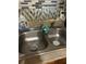 The kitchen features a stainless steel double basin sink, with a tiled backsplash at 330 S Buena Vista Ave, Orlando, FL 32835