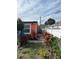 View of the side yard with lush greenery, plants and a side view of the orange home at 330 S Buena Vista Ave, Orlando, FL 32835