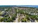Aerial view showcasing a neighborhood bordered by lush trees and tranquil waters at 335 W Bay St, Winter Garden, FL 34787