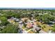 An aerial shot displays the surrounding neighborhood with lush greenery surrounding residential homes and streets at 335 W Bay St, Winter Garden, FL 34787