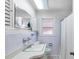 Bathroom with single sink, vanity, and tiled shower with curtain at 335 W Bay St, Winter Garden, FL 34787