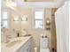 Bathroom with single sink, vanity, and tiled shower with curtain at 335 W Bay St, Winter Garden, FL 34787