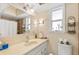 A bright bathroom with ample light, featuring a large mirror, sink, and toilet at 335 W Bay St, Winter Garden, FL 34787