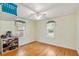Spare bedroom with hardwood floors, ceiling fan, and window views at 335 W Bay St, Winter Garden, FL 34787