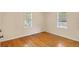 Cozy bedroom with hardwood floors and natural light from two windows at 335 W Bay St, Winter Garden, FL 34787