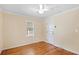 Comfortable bedroom with hardwood floors, ceiling fan, and natural light at 335 W Bay St, Winter Garden, FL 34787