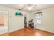 This bedroom features hardwood floors, a window with blinds, and a closet for ample storage at 335 W Bay St, Winter Garden, FL 34787